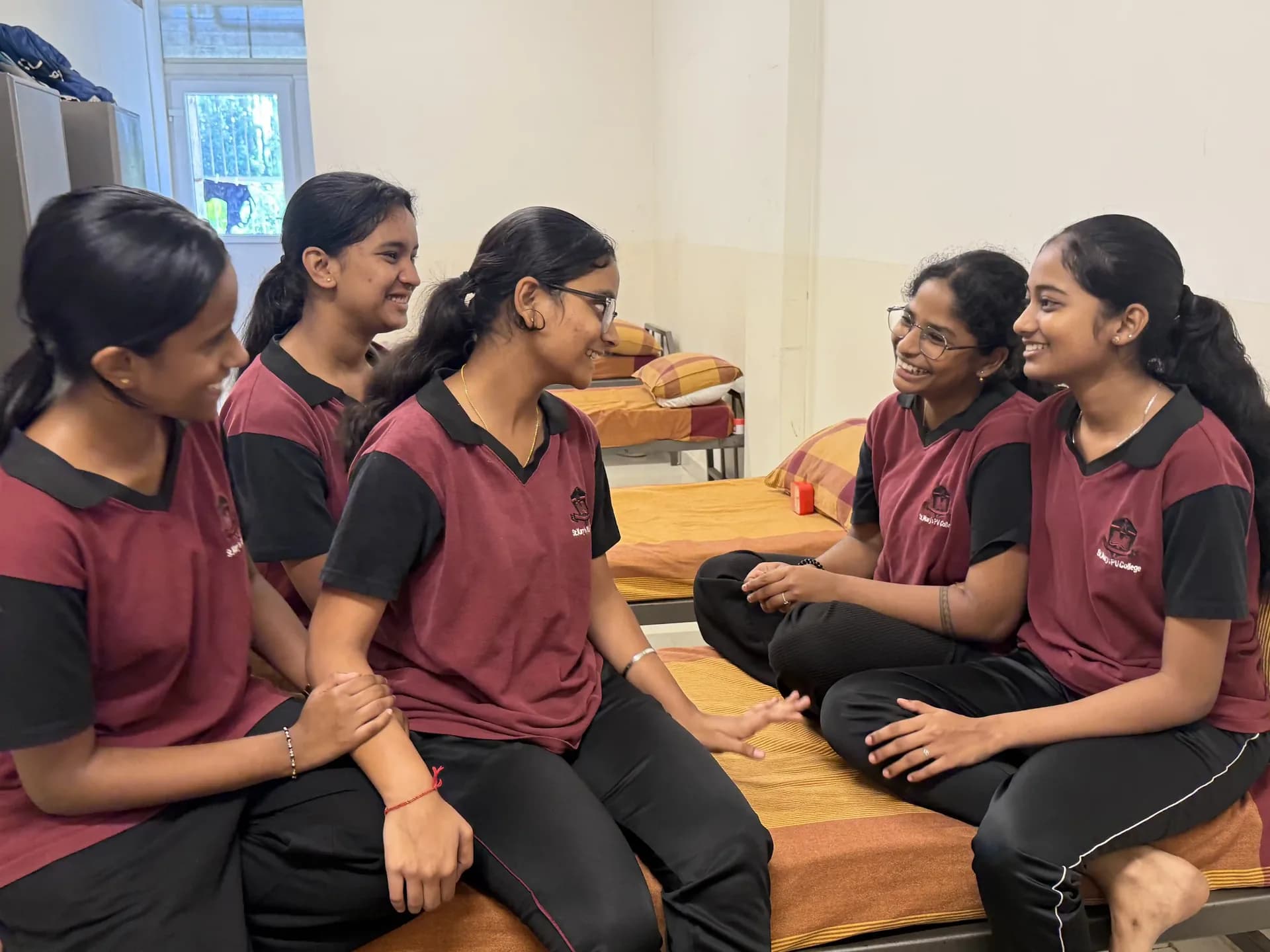 Students at Maggie House talking together in their room